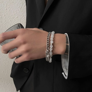 Close-up of double-layer stainless steel Cuban chain bracelet with star pendant and beads