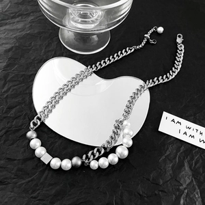 Unisex cuban chain necklace with pearls and metallic square slider on black background