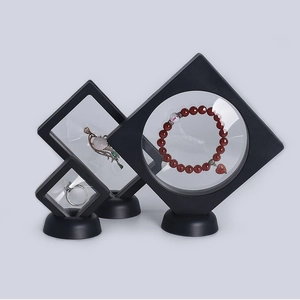 Three black PE film floating display boxes showing jewelry from a professional macro view