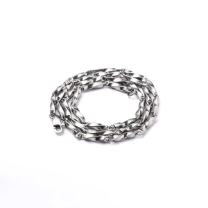 Detailed macro view of minimalist silver titanium steel twist chain with lobster clasp