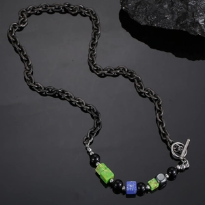 Detail of industrial bead necklace with green marble stones and vintage OT toggle clasp