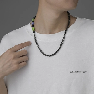 Retro hip-hop black onyx and colorful stone necklace with dark metal chain on model