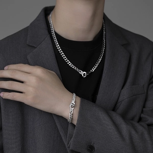 Polished silver cuban chain necklace and bracelet set with unique handcuff clasp for men