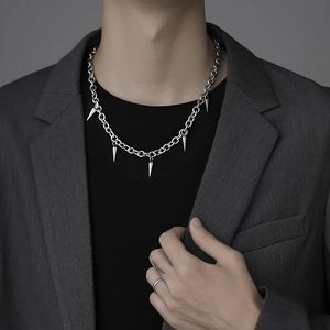 Punk style titanium steel chain necklace with silver spike pendants on male model