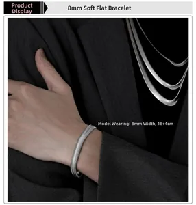 Detail view of 8mm wide silver flat snake bone chain bracelet with woven texture