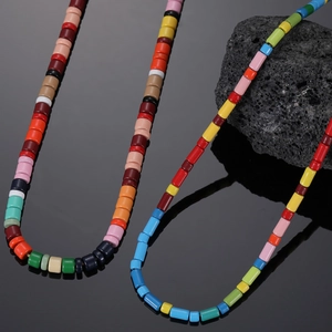 Colorful beaded rainbow necklace in bohemian style on volcanic rock background