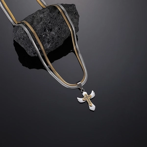 Detail of wings pendant with golden cross and crystals on double snake chain