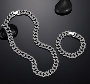 Detailed macro shot of silver Cuban link jewelry set with shimmering cubic zirconia