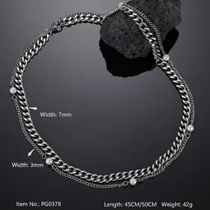Detail of layered stainless steel Cuban link and white pearl necklace with lobster clasp