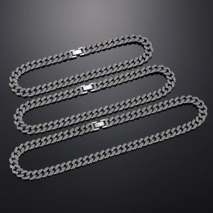 Macro view of full crystal pave Cuban link necklaces with high-shine metal buckle