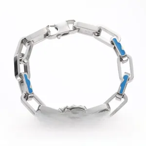 Detail of titanium steel bracelet with gold lightning bolt and blue wave pattern links
