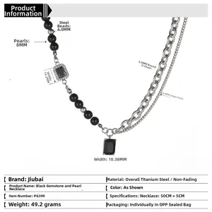 Detail view of steel necklace with black gemstones, pearls and layered chains specs