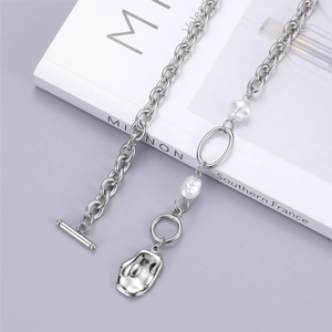 Detailed view of silver irregular pendant with baroque pearls and OT toggle clasp