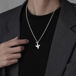 Men's minimalist titanium whale pendant necklace with silver airplane design on model