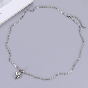 Detail of silver airplane pendant with rose gold ring connector and lobster clasp