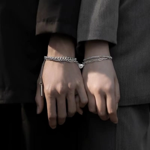 Matching magnetic heart bracelets for couples featuring silver Cuban and clip link chains