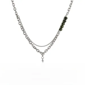 Detail of titanium steel double-layer necklace with green pearls and square pendant