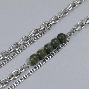 Detail of double-layer titanium steel chain featuring five dark green gemstone beads