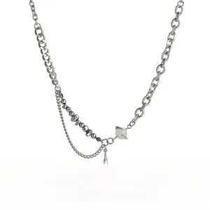 Detail of titanium steel necklace with star pendant and cat eye stone on white background