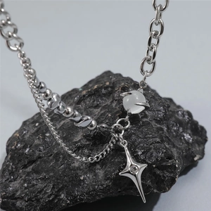 Titanium steel star eye necklace featuring cat eye stone and mixed silver chains on rock