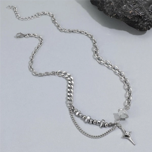 Detailed view of titanium steel star and cat eye stone pendant on a mixed metal chain
