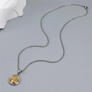 Detailed close-up of a dual-tone poker and dice pendant on a titanium steel chain