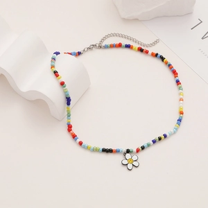 Close-up of bohemian colorful beaded daisy necklace with a white smiley face flower pendant