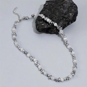 Macro detail of pearl and irregular silver beads with lobster clasp and extension chain