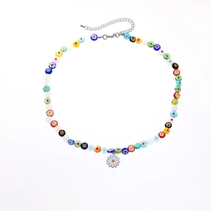 Close-up of colorful glass beads and enamel daisy pendant on a stainless steel necklace