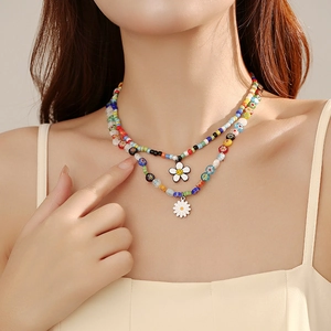 Double-layered daisy bead necklace with colorful pearls and a smiley face charm
