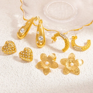 Detail view of 4-pair gold earring set with heart, drop, C-shape, and pearl flower designs