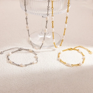 Detailed close-up of 18K gold stainless steel freshwater pearl necklace and bracelet set