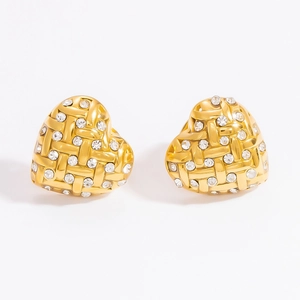 Macro view of gold heart stud earrings featuring a woven texture and inlaid crystals
