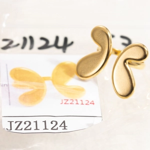 Detail of golden adjustable ring featuring a matte textured irregular butterfly shape