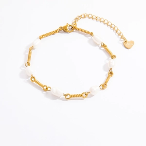 Detailed macro view of 18K gold-plated rope chain bracelet with freshwater pearls