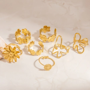 Detailed view of a 7-piece gold adjustable ring set with floral and butterfly motifs