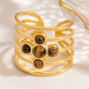 Macro detail of multilayer 18K gold stainless steel ring with five tiger eye stones