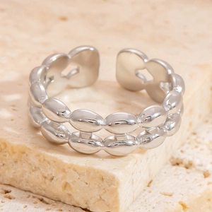 Detail view of silver double-row chain ring with star-shaped cutout on adjustable band