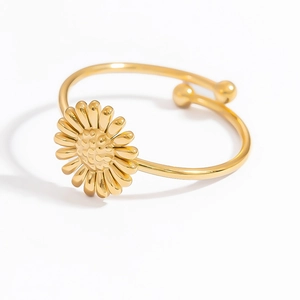 Macro detail of adjustable gold daisy ring featuring a polished floral texture