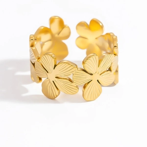 Macro detail of adjustable gold floral ring with engraved radial petal textures