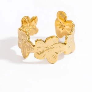 Detailed close-up of golden stainless steel open ring with continuous floral petal design