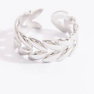Macro shot of polished silver leaf ring with adjustable open band and laurel grain texture
