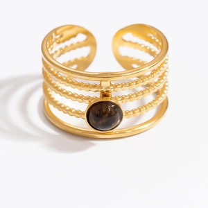 Detail of multi-layer 18K gold stainless steel ring with a brown tiger eye gemstone