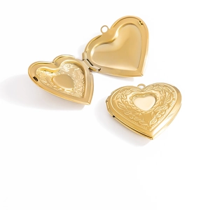 Detailed view of heart locket pendant with floral engraving in open and closed states
