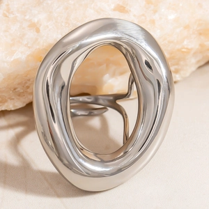 Macro detail of silver liquid metal irregular hollow ring on textured stone
