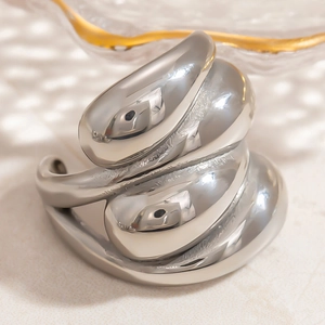 Macro shot of silver liquid metal irregular ring with mirror-polished surface and texture