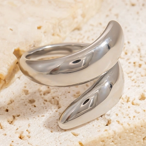 Close-up of polished silver adjustable ring with sculptural wrapping design on stone base