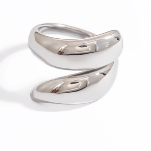 Detailed view of irregular silver wave ring showing polished metallic mirror finish