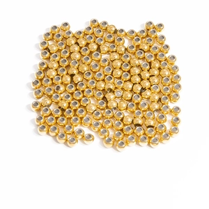 Macro shot of bulk large-hole 18K gold plated metal beads for DIY jewelry making