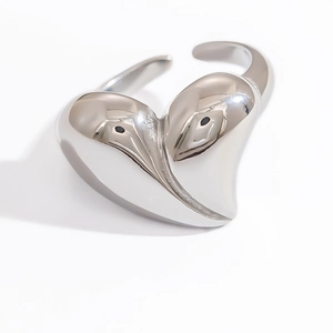 Macro detail of silver adjustable open ring with abstract bird shape and polished finish